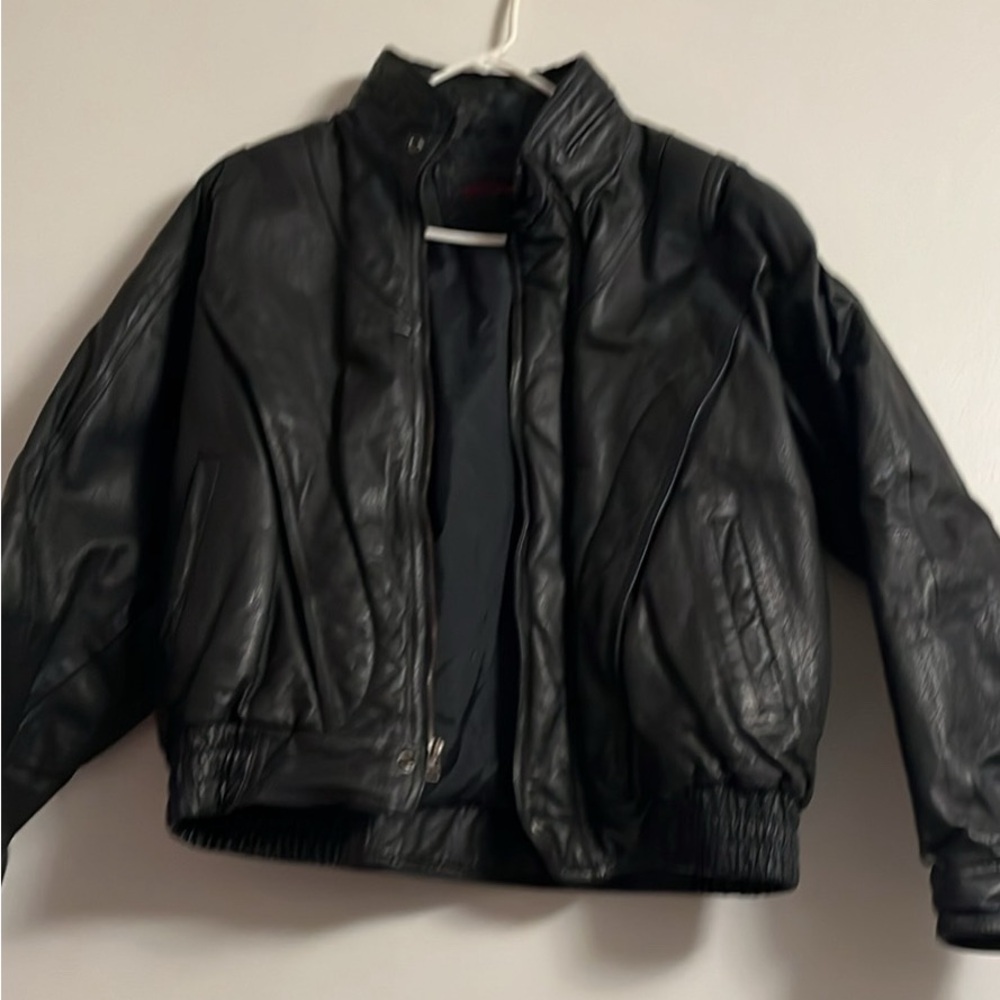 A vintage mirage, black leather bomber jacket